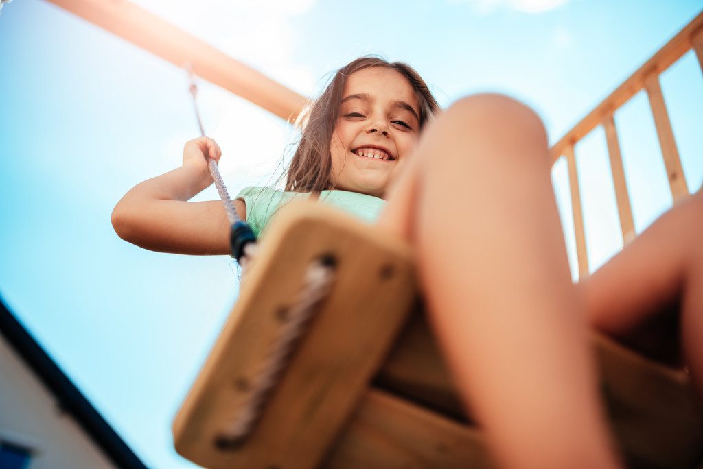 criança se divertindo em balanço em playground para condominio