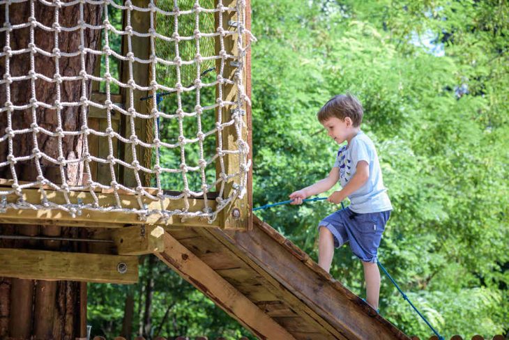 menino subindo em brinquedo de playground de crianças